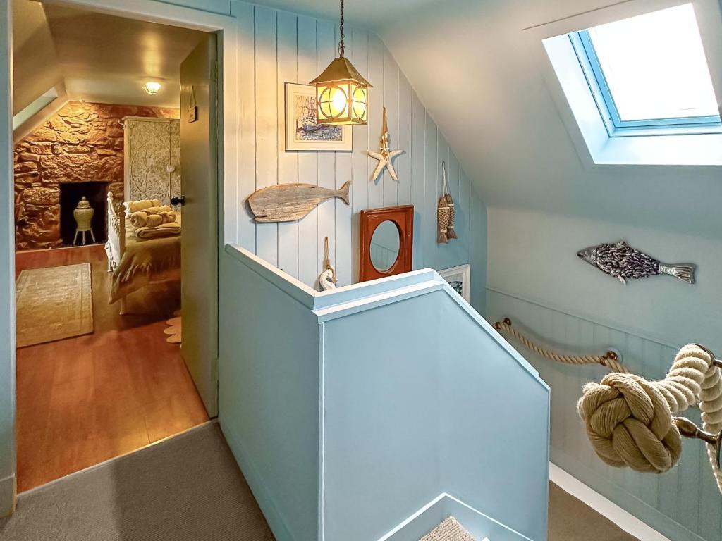 an attic hallway with a staircase with a skylight at Coast Away in Fraserburgh