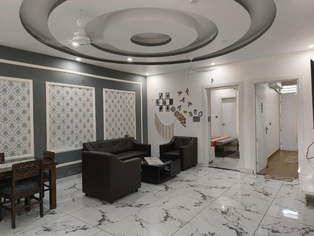 a living room with a couch and a ceiling at Stay in peace in Dehradun