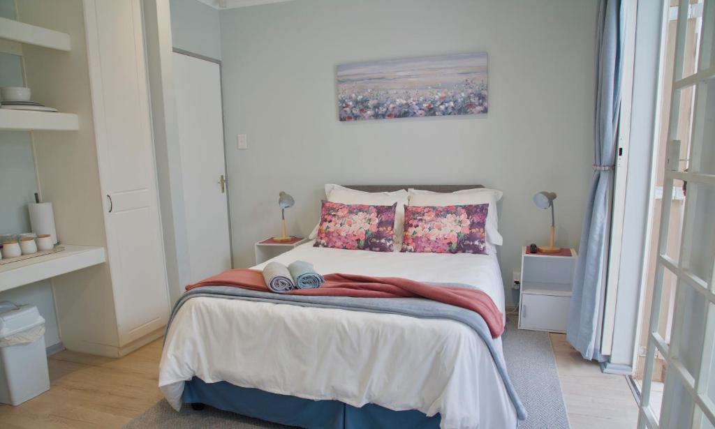 a bedroom with a bed with two pillows at Naval Hill Nook in Bloemfontein