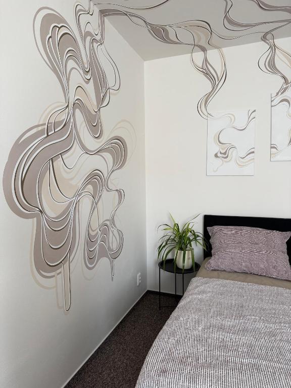 a bedroom with a bed and a wall mural at Penzion Pollet in Pilsen