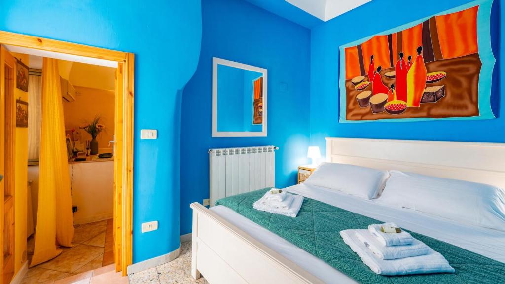 a blue bedroom with a bed with towels on it at Casa Zefiro by Rentbeat in Ostuni