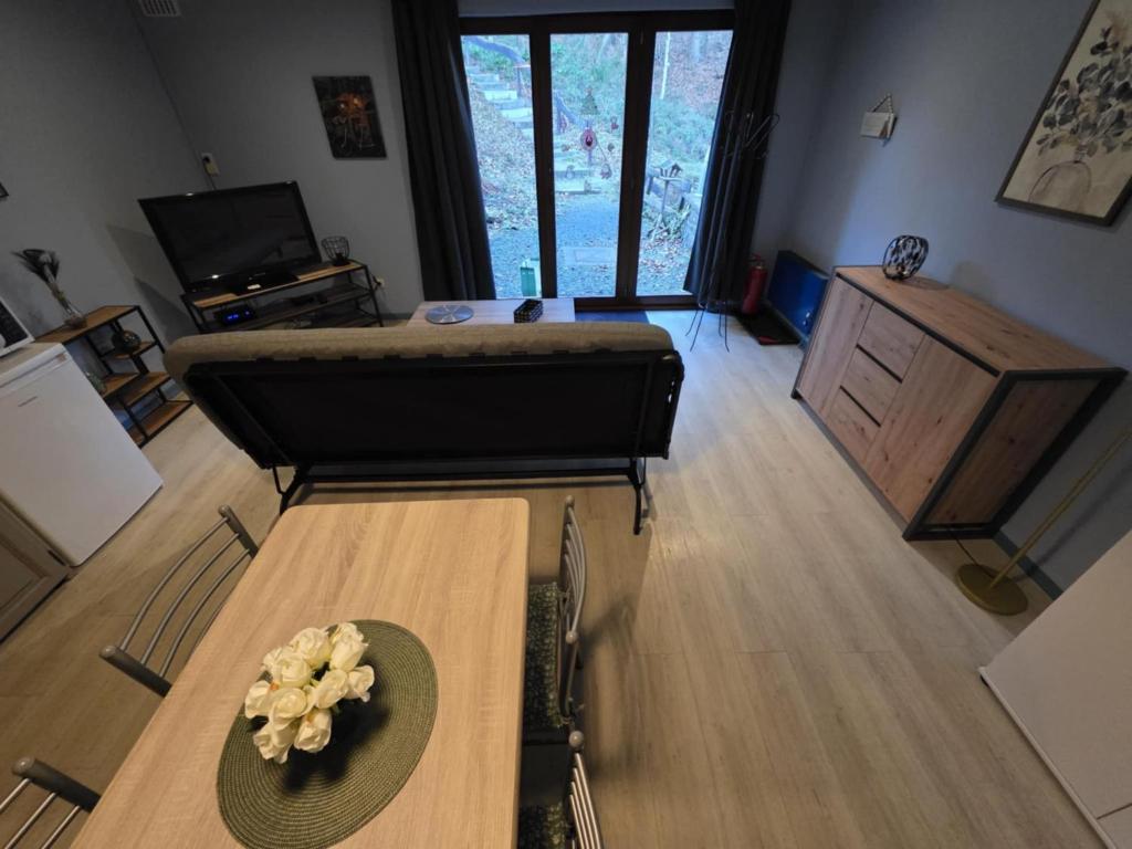a living room with a table with a hat on it at L'Orée du bois in Membre