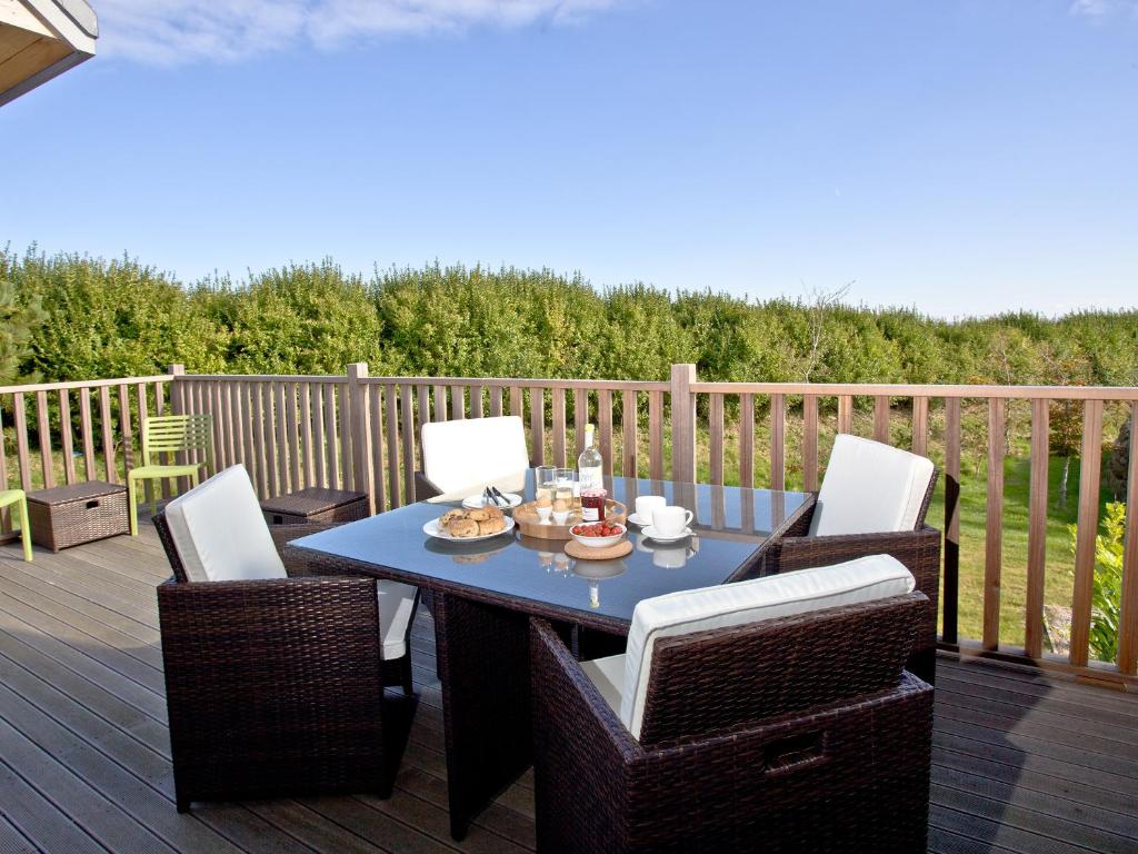 a blue table and chairs on a deck at Una Aurum 56 in St Ives