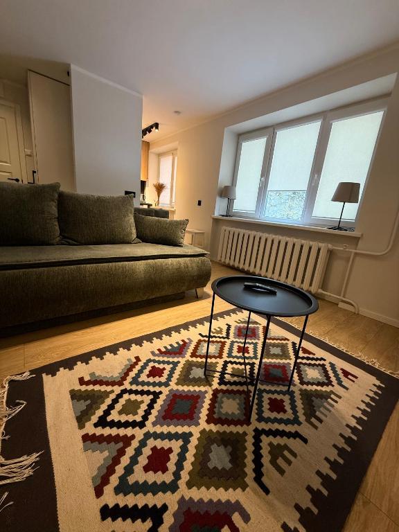 a living room with a couch and a table at Apartamenti Ikšķile in Ikšķile