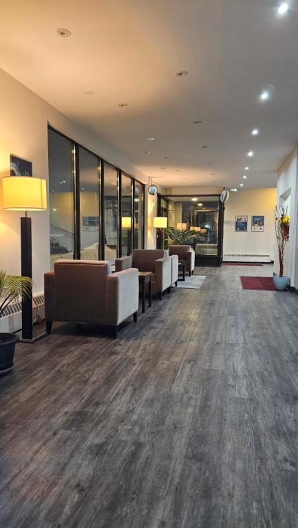a lobby with couches and chairs in a building at Motel 6 Sault Ste. Marie, ON in Sault Ste. Marie