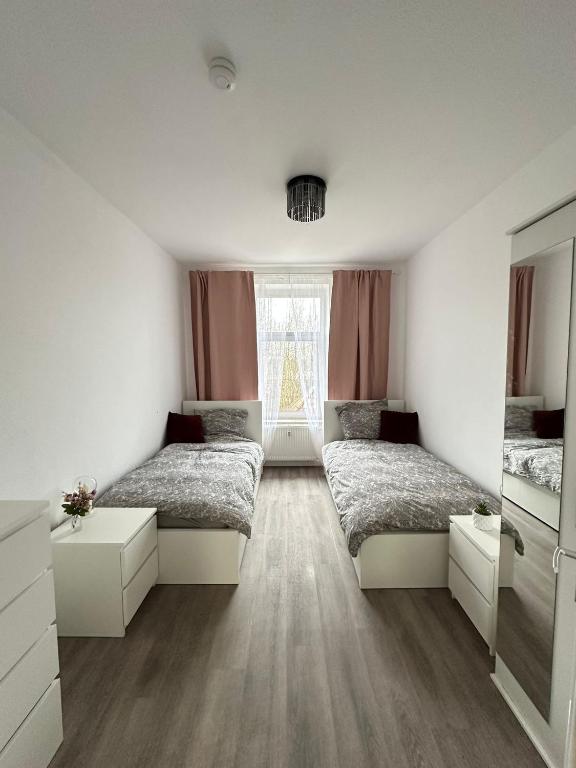 a bedroom with two beds and a window at Apartment Brunsbüttel 3 in Brunsbüttel