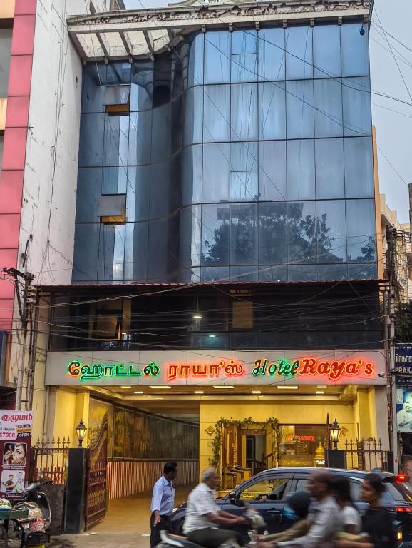 people riding motorcycles in front of a building at Hotel Raya's Annexe 1 in Kumbakonam