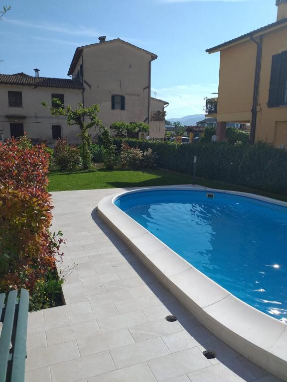 a swimming pool in a yard next to a house at House Barbanera in Spello