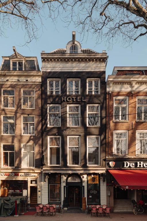 a large building with a hotel on a street at Adam Downtown in Amsterdam