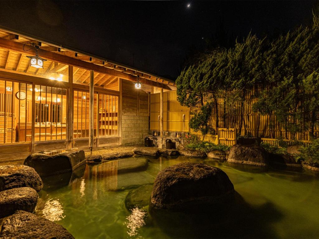 a large pool of green water in a building at かね吉一燈庵 in Mitaka