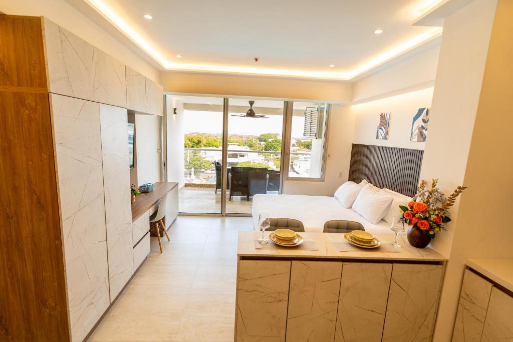 a hotel room with a bed and a kitchen at Magica Cartagena Suite in Cartagena de Indias