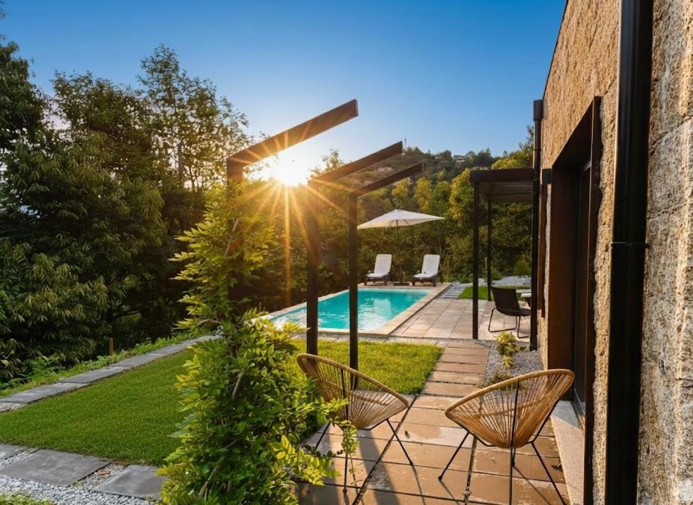 a patio with two chairs and a swimming pool at Chestnut hill - Geres in Ventosa