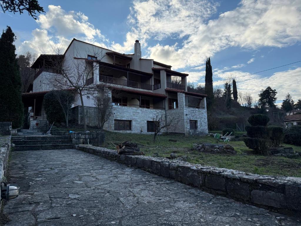 a house with a stone path in front of it at Driades in Kalavrita
