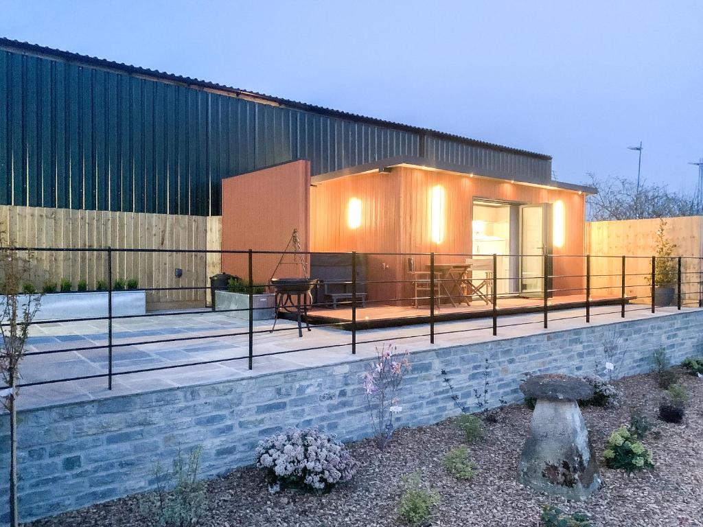 a house with a deck and a building at The Pod - Uk38513 in Babcary