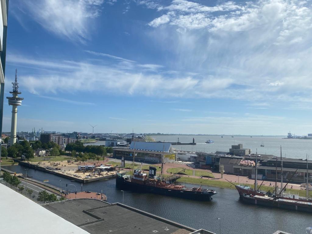 a view of a harbor with boats in the water at Ferienwohnung Deichblick in Bremerhaven