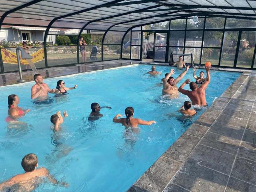 a group of people in a swimming pool at ZEcamping 4 étoiles piscine couverte piscine chauffée locatif 4 pers in Wavans