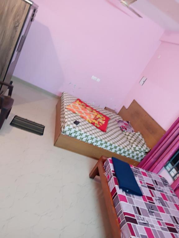 a room with a bed and a box on the floor at Roamwander doublerooms in Vagamon