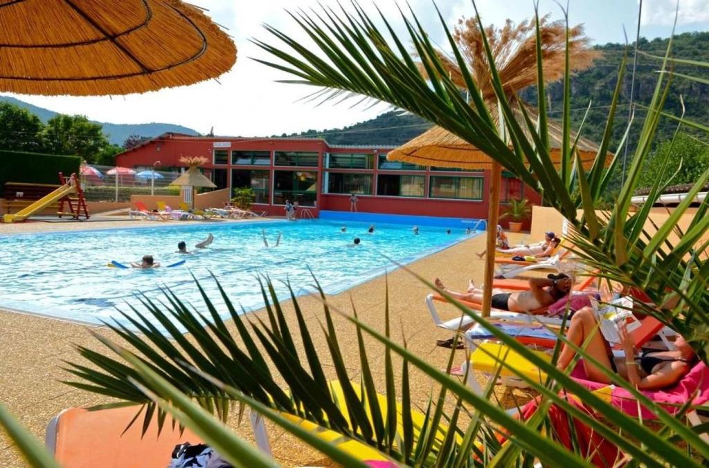 a pool at a resort with people swimming at ZEcamping 4 étoiles familial animaux acceptés animé équitation in Saint-Rome-de-Tarn
