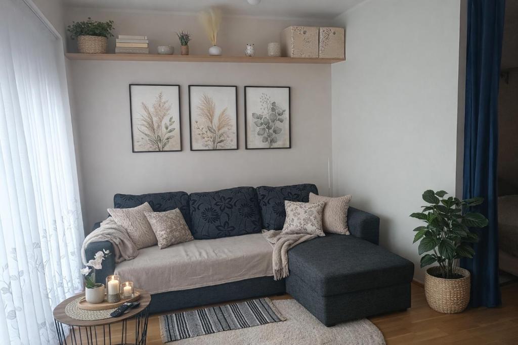a living room with a blue couch and a table at Jõekalda kodu in Pärnu