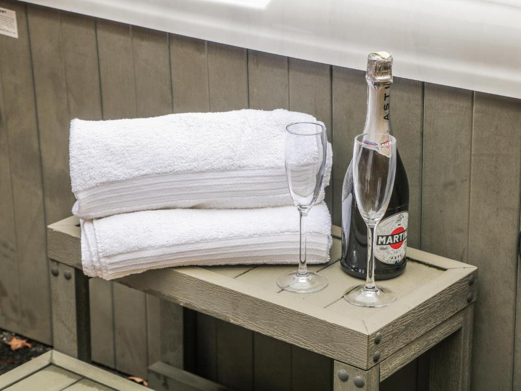 a bottle of champagne and a glass on a table at Courtyard View in Ashbourne