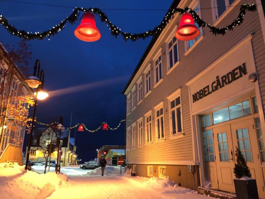 a street with christmas lights and a building at Nobelgården in Harstad
