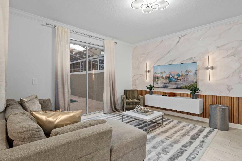 a living room with a couch and a table at Special 4bedroom TH w-private pool next to Disney in Kissimmee