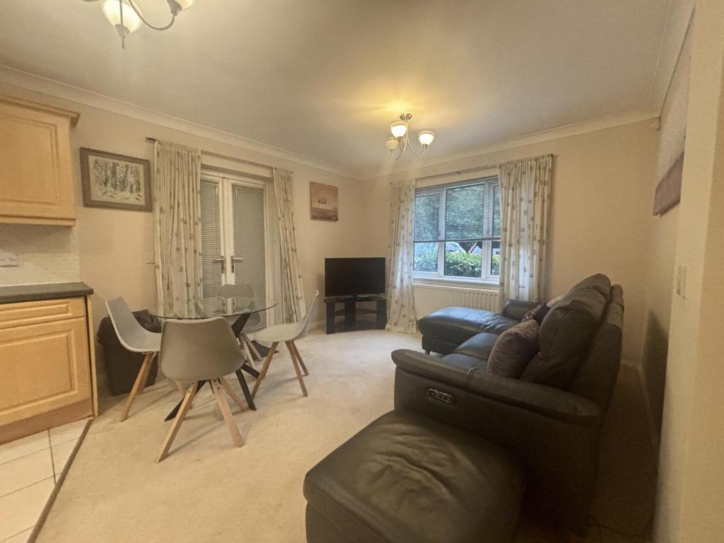 a living room with a couch and a table at Bracknell Spacious 2 Bedroom Apartment in Bracknell