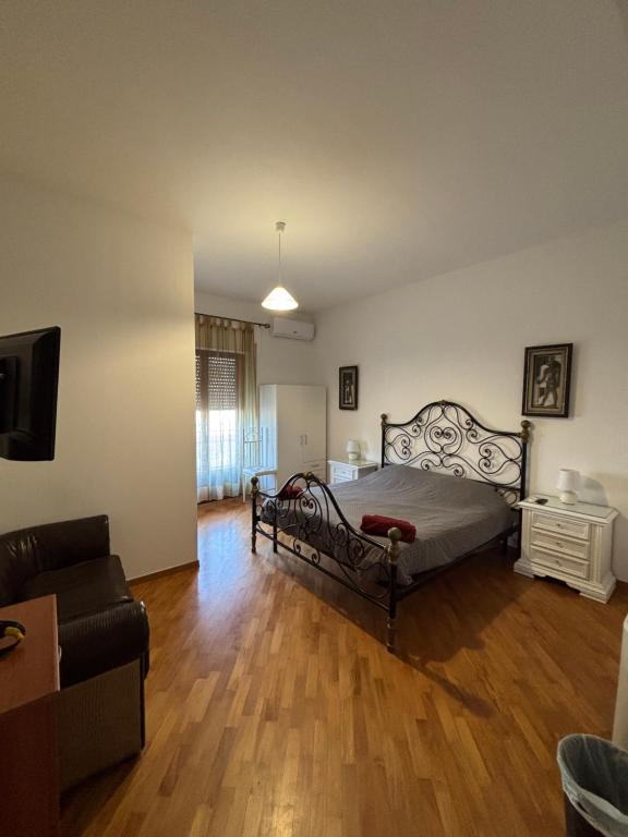 a bedroom with a bed and a living room at Casa Alighieri in Montalto Uffugo