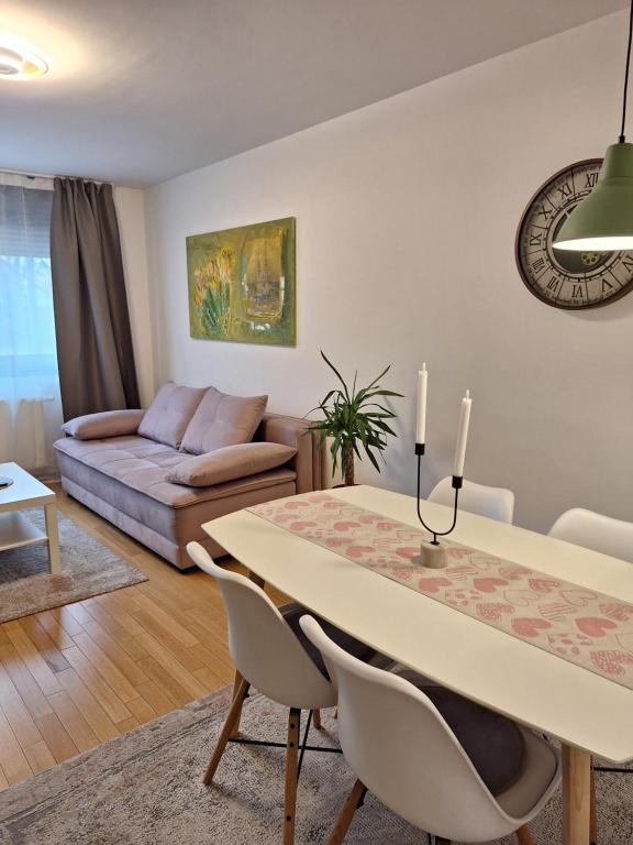 a living room with a table and a couch at Apartman Lory, Zagreb, Downtown, with own parking in the garage in Zagreb