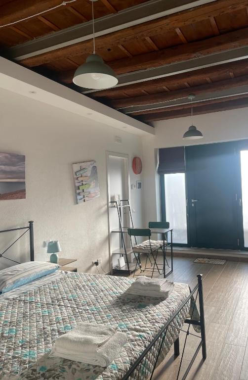 a bedroom with a bed and a table and chairs at Antico Borgo in Ancona