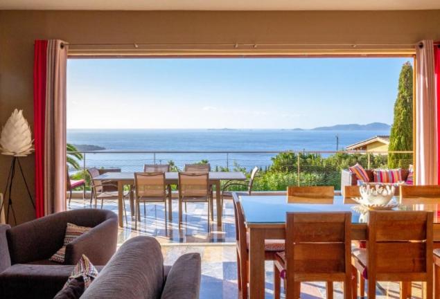 a living room with a view of the ocean at Villa Pierretti - Vue mer Panoramique in Coti-Chiavari