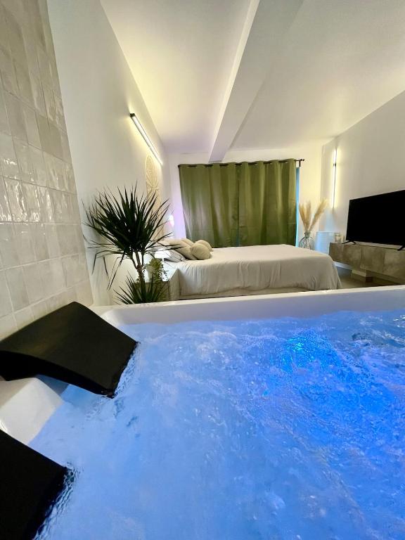 a room with a large swimming pool with a bed at Romantic Suite & Jungle in Longjumeau