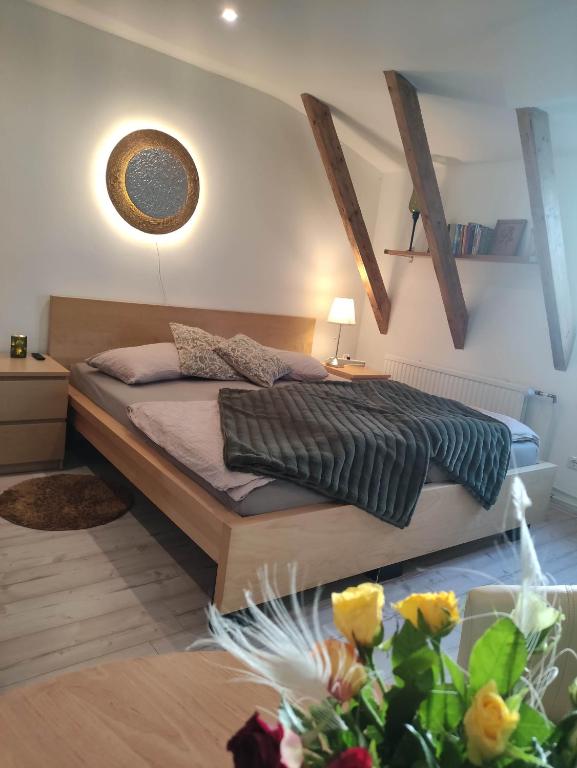 a bedroom with a bed and a table and flowers at Eider in Karolinenkoog