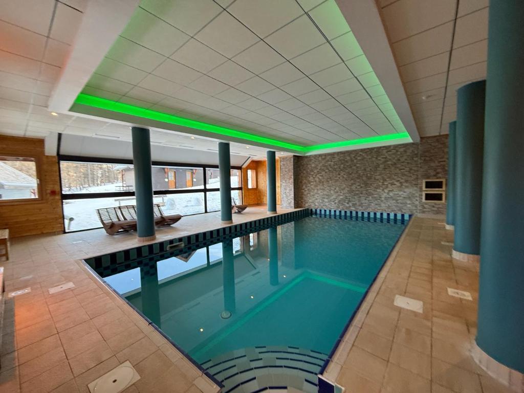 a large swimming pool in a building at Appt 2Pièces-6pers - Balcons de Sirius, Piscine et Sauna in Risoul
