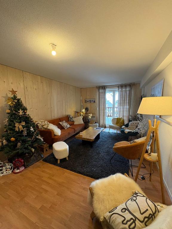 a living room with a christmas tree in it at "1-2-3 SOLEIL" Duplex - 8 pers - La Mongie Pic d'espade in La Mongie