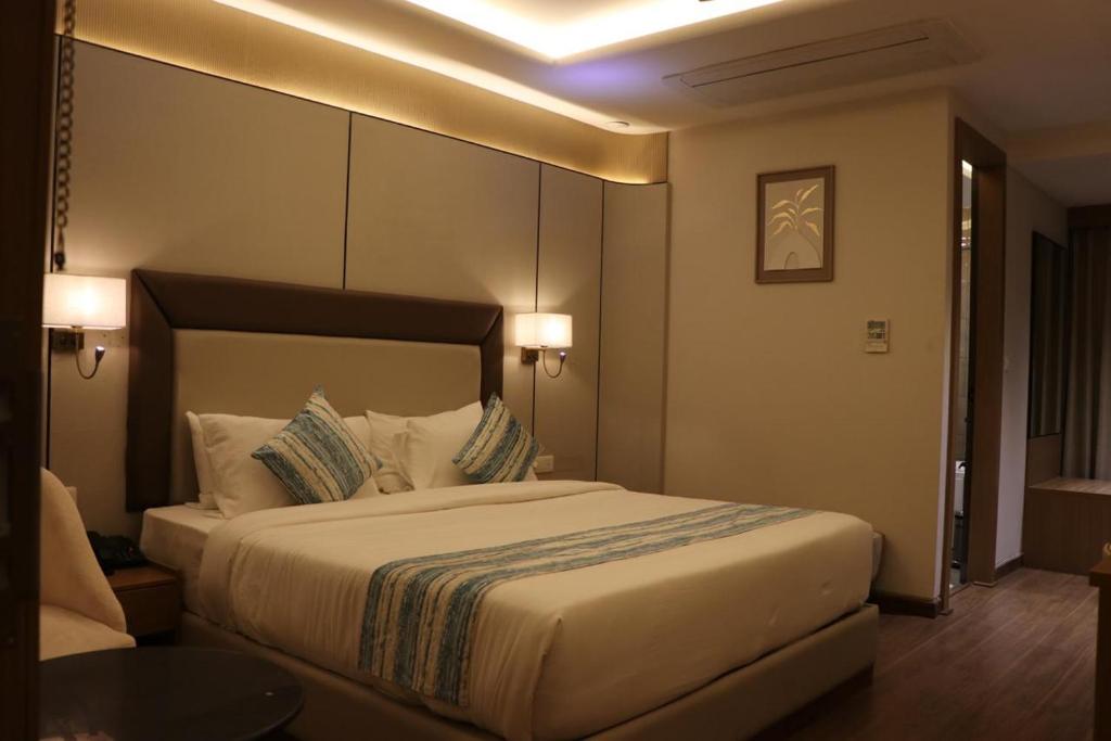 a bedroom with a large bed in a hotel room at Lalit hotel in Udaipur