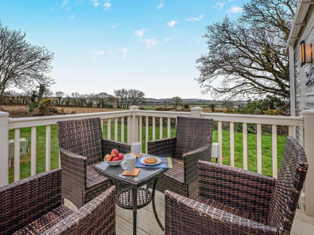 a table with a bowl of fruit on a balcony at 3 Bed in Ventnor oc-94278 in Rookley