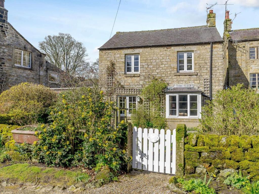 an old brick house with a white fence at 3 Bed in Harrogate oc-87478 in Bouthwaite