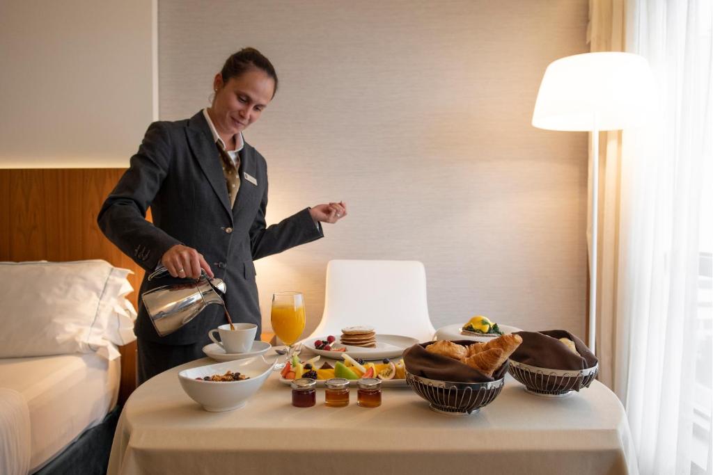 An in-room breakfast spread arranged beside the bed.