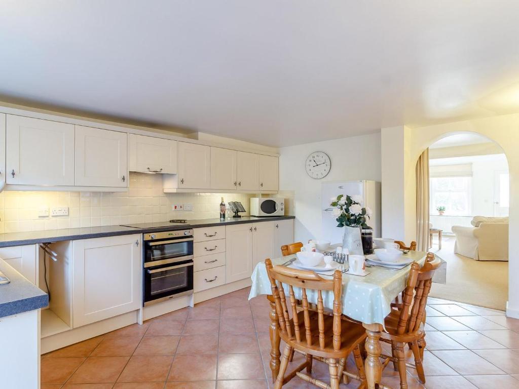 a kitchen with a table and chairs in a kitchen at 2 Bed in Holt oc-ncc11 in Holt