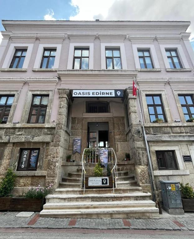 a large building with stairs in front of it at Oasis Pansiyon in Edirne