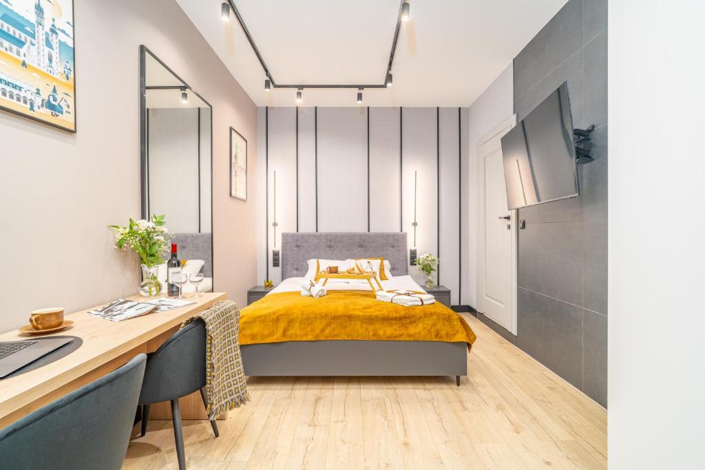 a small bedroom with a bed and a desk at S12 Premium Apartments - by Hosty in Krakow