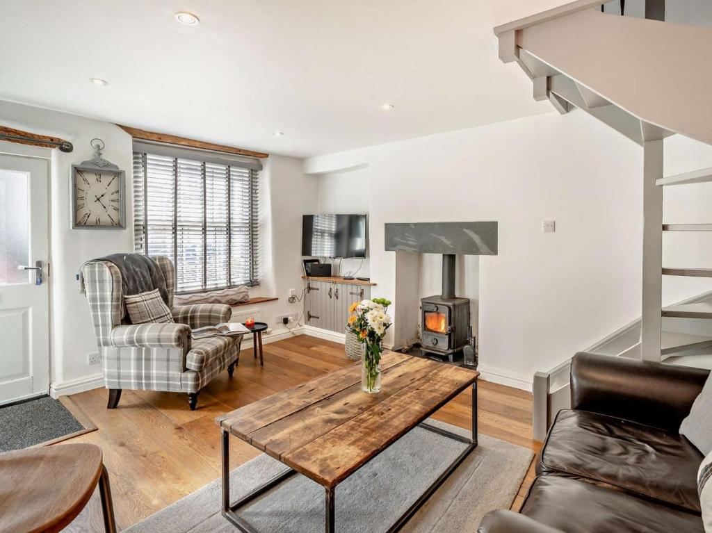 a living room with a table and a fireplace at 1 Bed in Kendal oc-94210 in Kendal