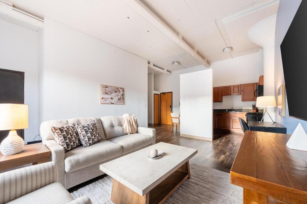 a living room with a couch and a table at Landing Apartments - Stockbridge Court in Springfield