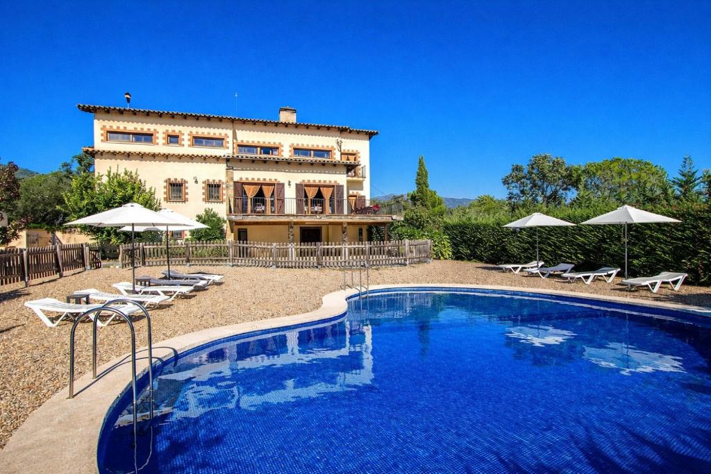 a large swimming pool in front of a building at Catalunya Casas Nature and Tranquility for 24 pax - 30km to beach in Sant Pere de Vilamajor