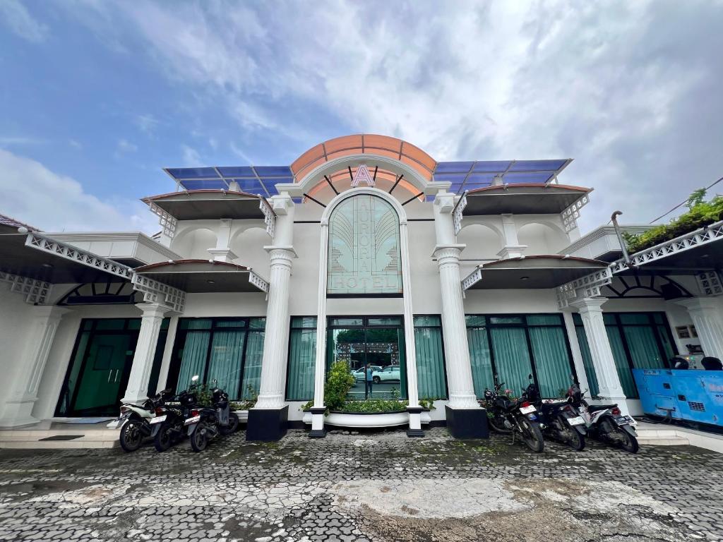 a group of motorcycles parked in front of a building at Aurora Hotel Kartini in Cirebon