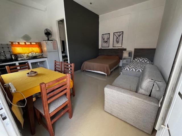 a kitchen and living room with a table and a couch at Viva apart in Fiambalá