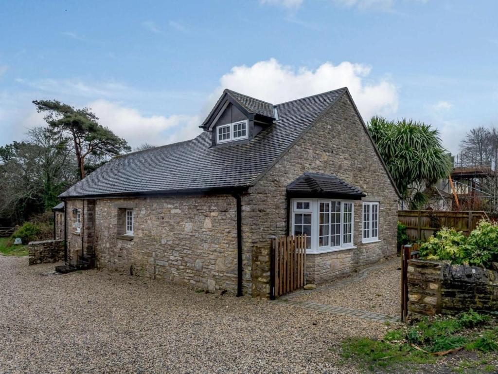an old stone building with a window on it at 3 Bed in Wareham oc-81369 in Corfe Castle