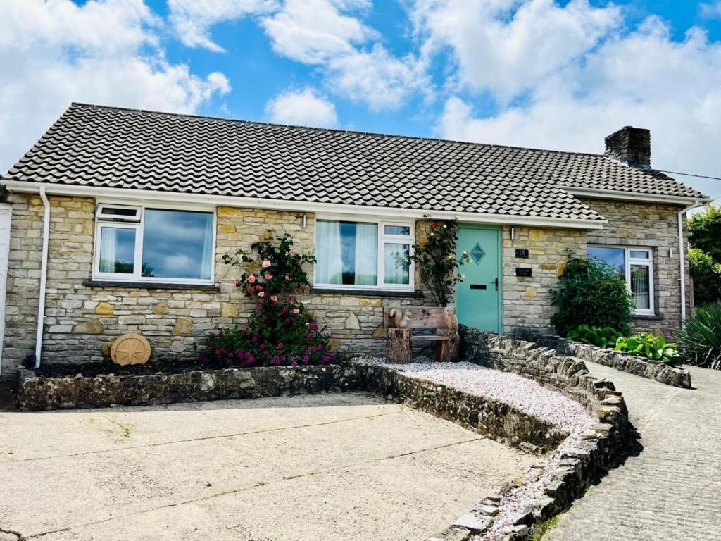 a stone house with a blue door at 3 Bed in Wareham oc-86239 in Corfe Castle