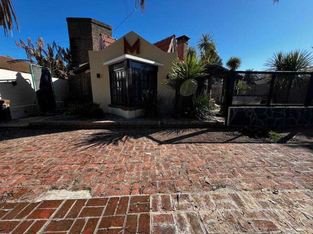 a brick driveway in front of a house at La Huella in Chascomús